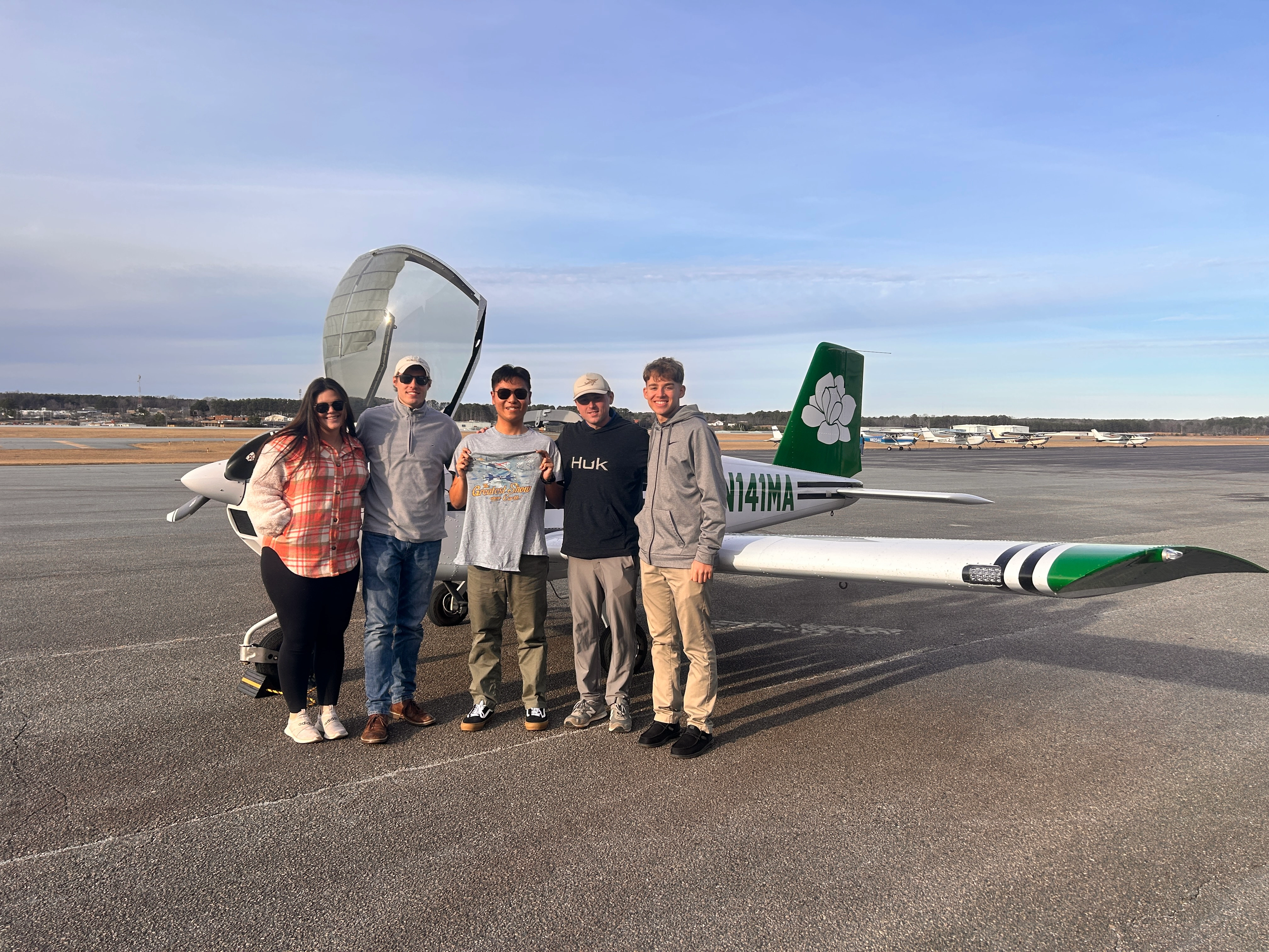 Magnolia Aviation Academy students and instructors in front of training aircraft