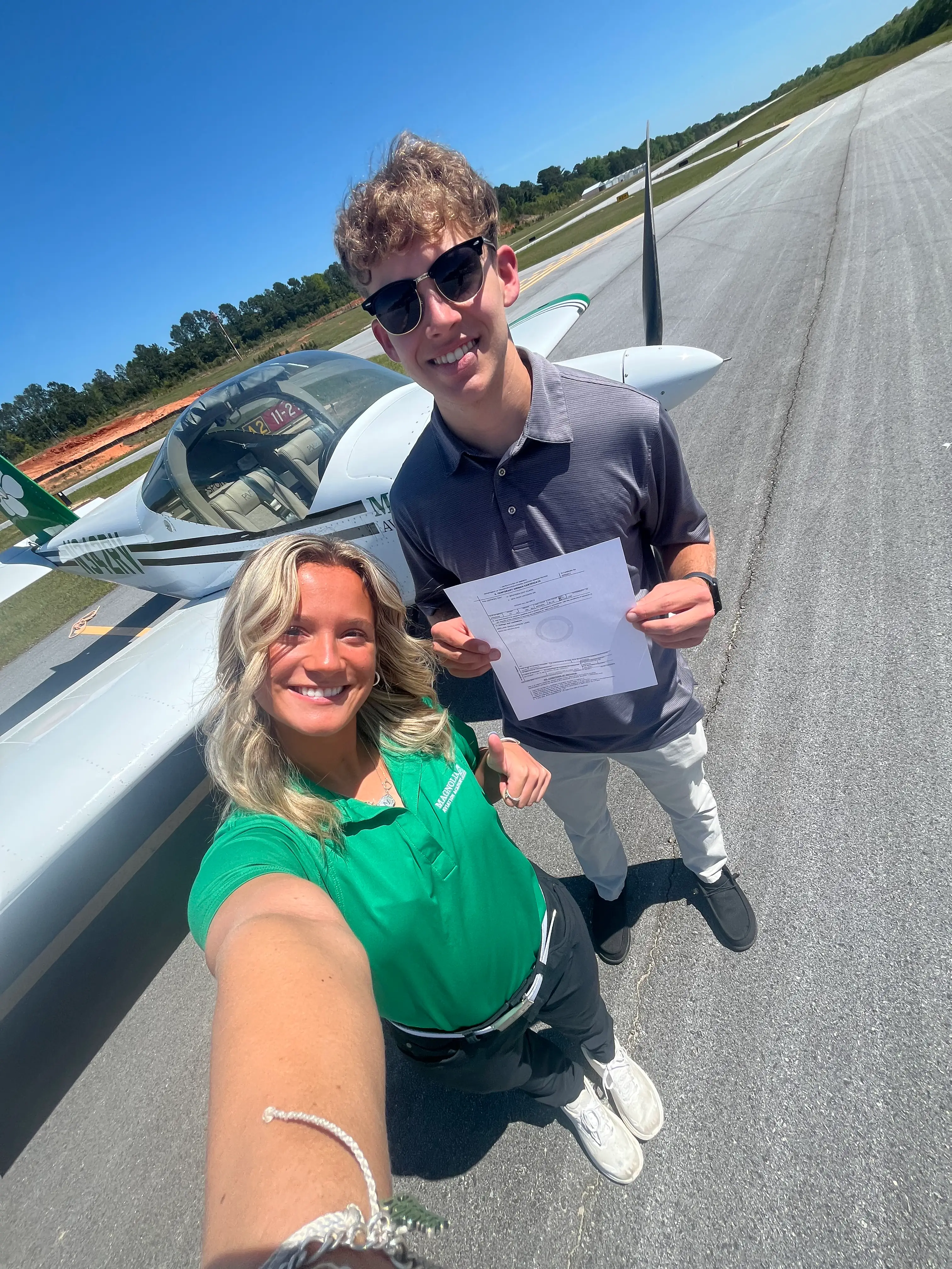 Magnolia Aviation Academy female cfi with student up top selfie