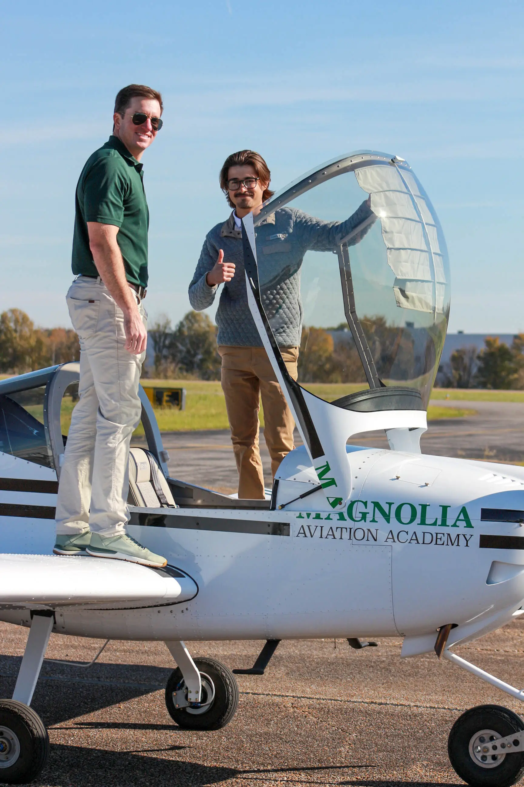 Magnolia Aviation Academy fleet flying near city skyline