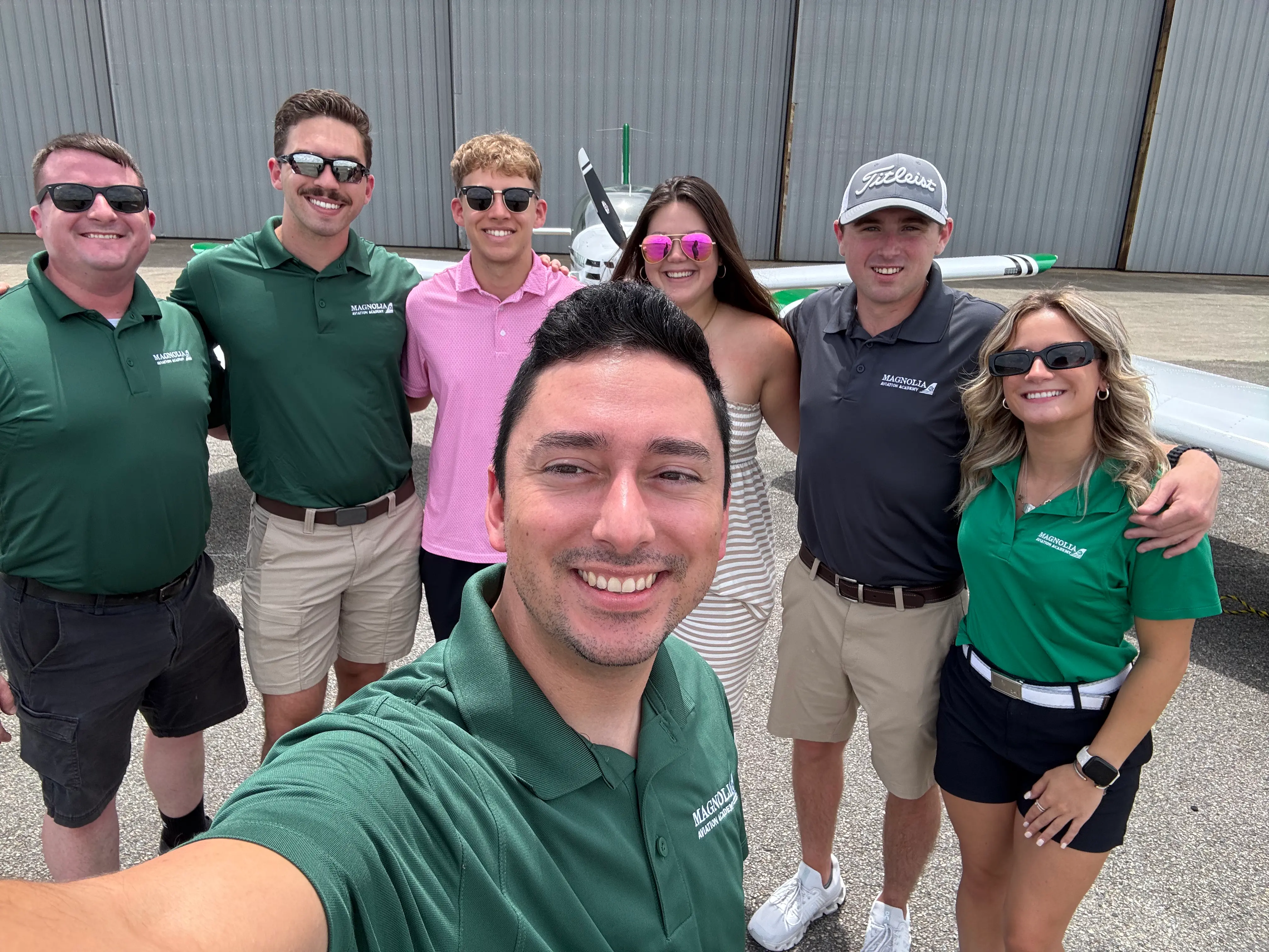 Magnolia Aviation Academy students standing by flight training aircraft